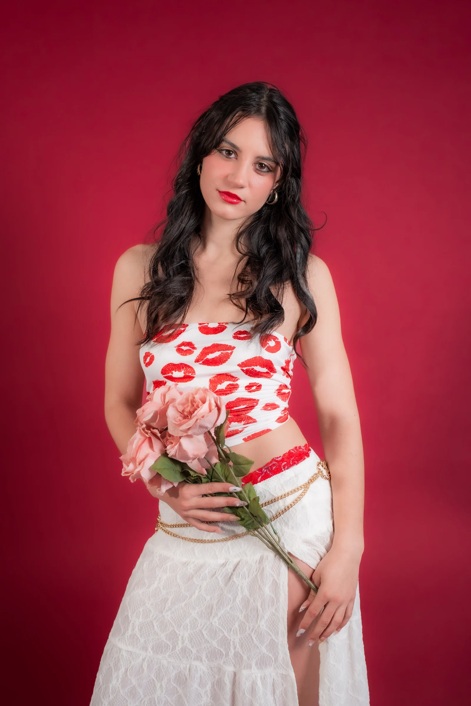 Kansas City portrait photography of woman holding flowers against red background