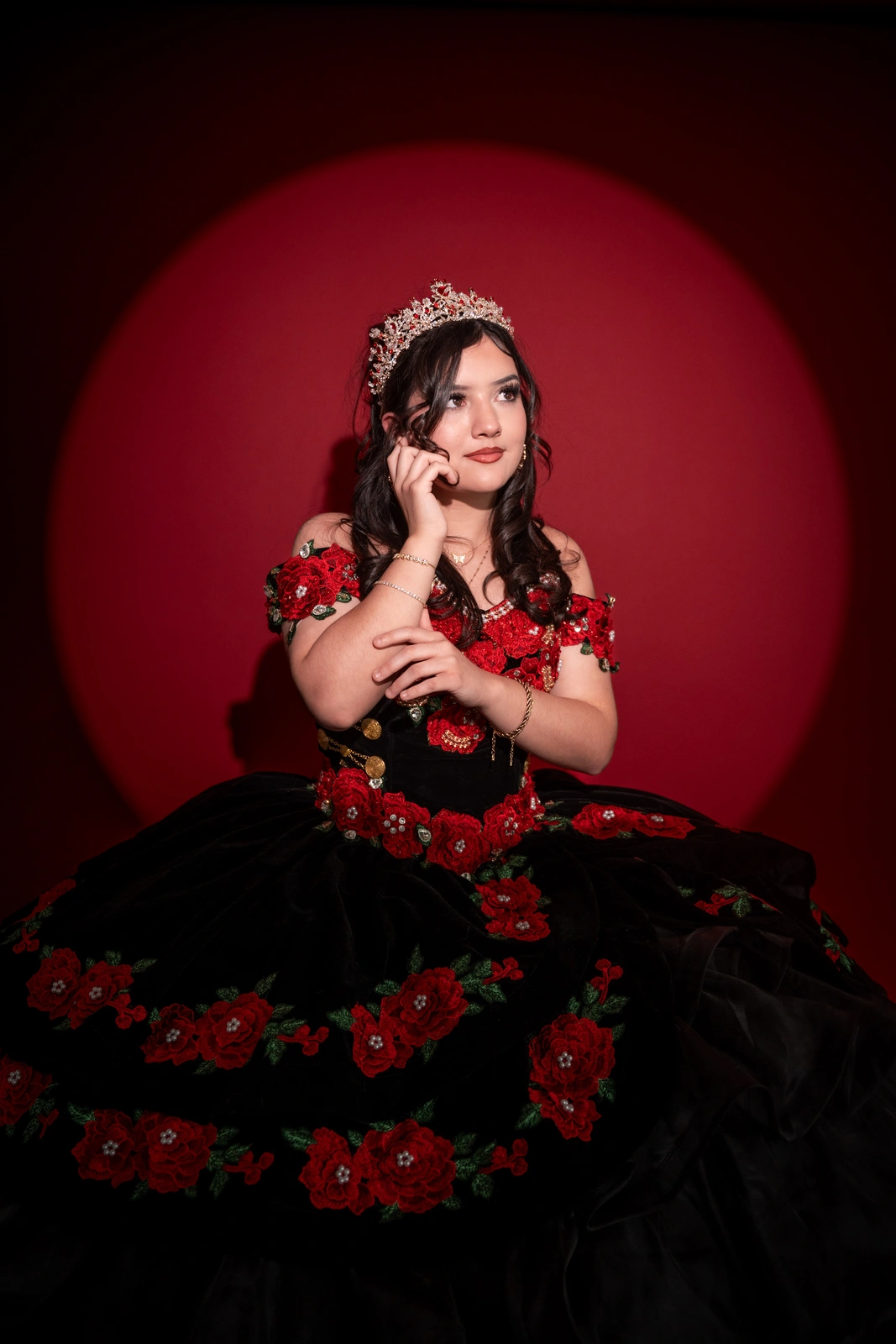 Quinceañera portrait in Kansas City sitting on stool wearing black and red dress