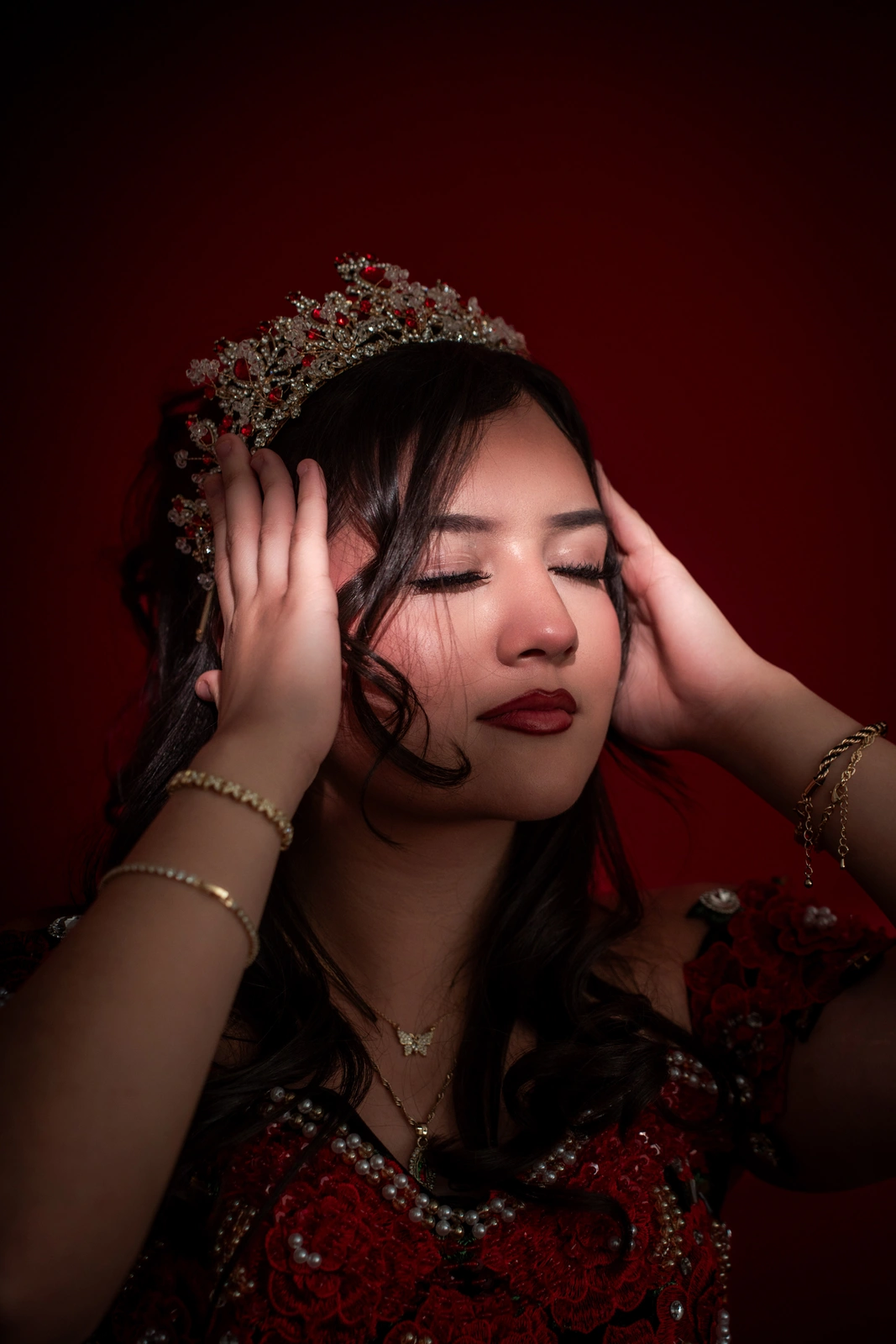 Artistic quinceañera close-up in Kansas City with eyes closed wearing crown