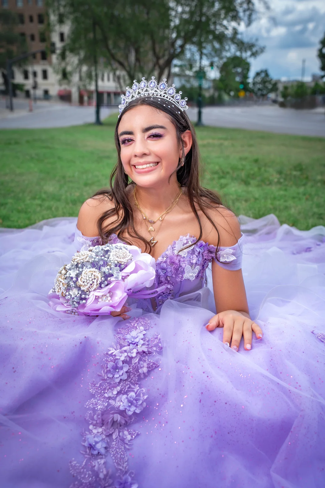 Close portrait of quinceañera in Kansas City wearing purple dress and holding bouquet