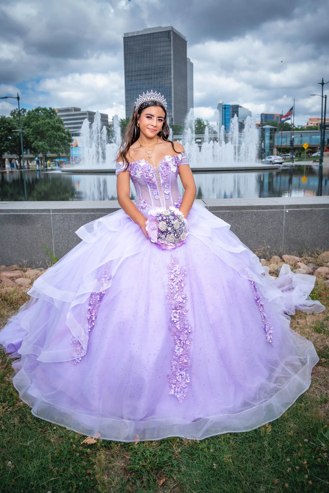 Kansas City quinceañera portrait in front of fountain wearing purple dress by Union Station