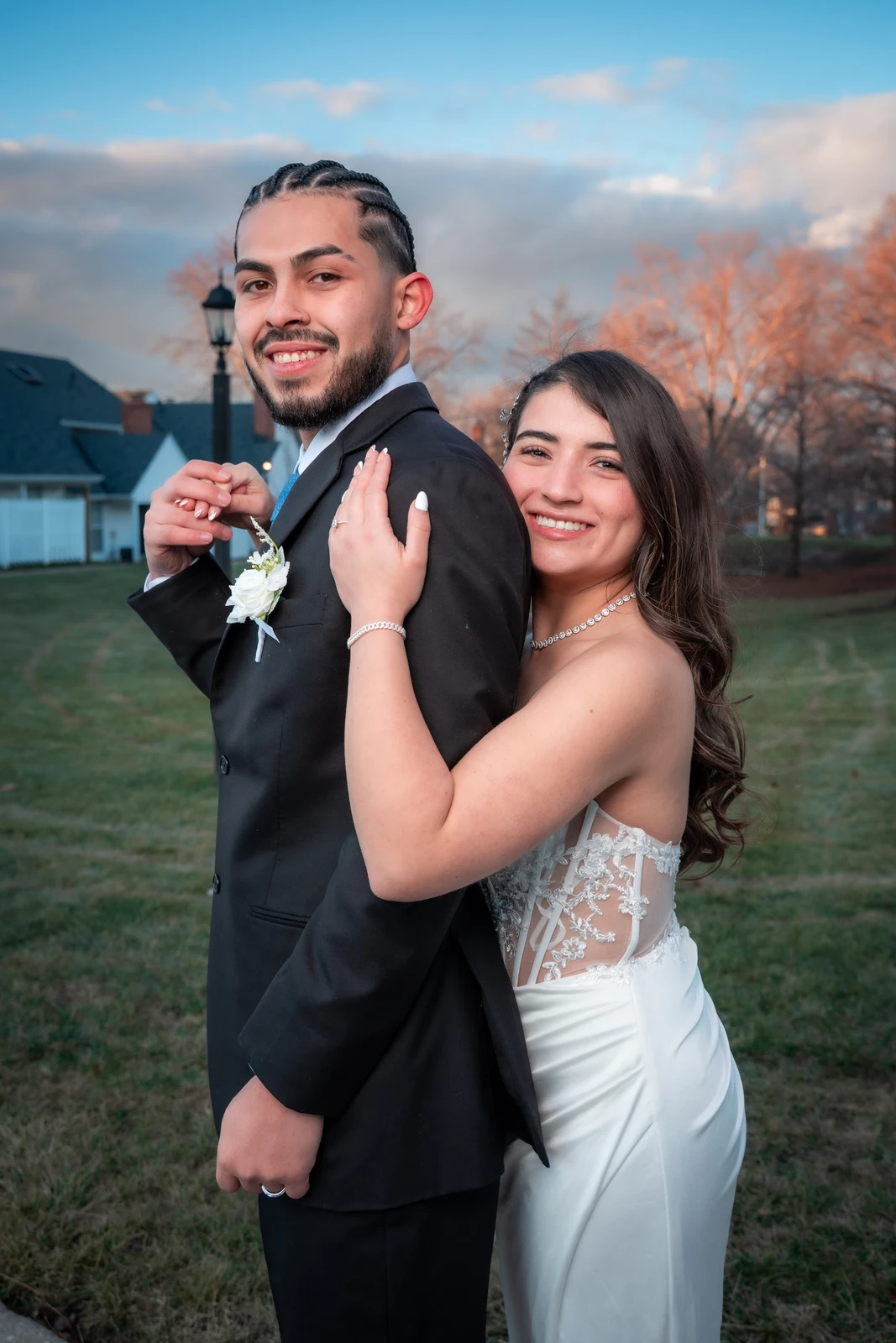 Romantic wedding couple portrait outdoors at sunset in Kansas City with bride hugging groom from behind