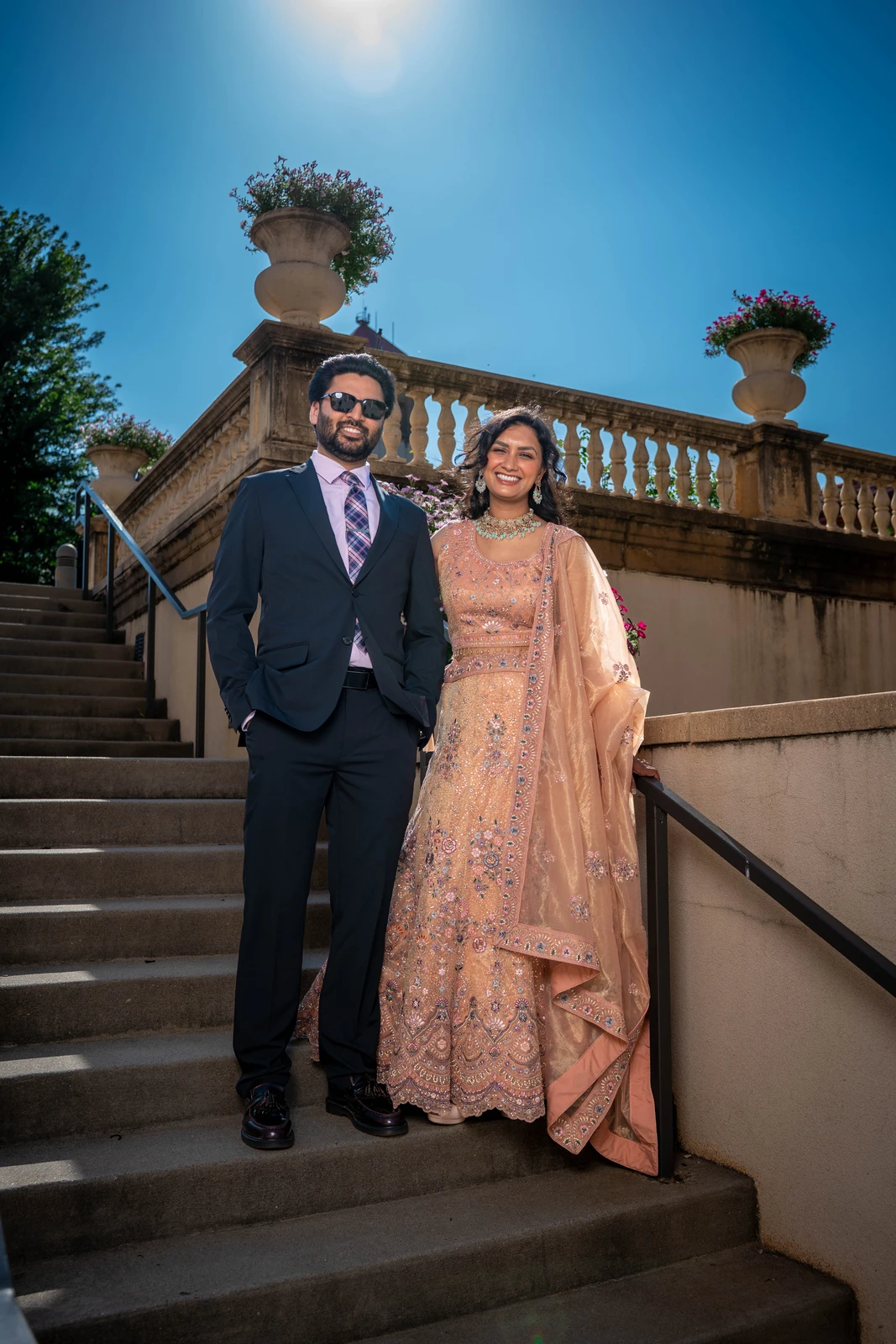 Indian wedding couple standing on stairs during outdoor portrait session in Kansas City